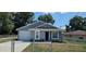 Charming single-story home featuring a well-maintained lawn and a classic architectural design at 1318 Herschell St, Lakeland, FL 33815