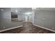 Open-concept living room and kitchen area with hardwood floors and ample natural light at 1318 Herschell St, Lakeland, FL 33815