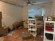 Living room view with sofa, ceiling fan, mini blinds, boxes and shelving at 12849 Madison Pointe Cir # 204, Orlando, FL 32821