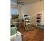 Cozy living room featuring laminate floors, a ceiling fan, and abundant natural light from the window at 12849 Madison Pointe Cir # 204, Orlando, FL 32821