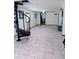 This is an empty basement that has a ceiling fan, a spiral staircase, and tiled flooring at 2073 Cr 428, Lake Panasoffkee, FL 33538