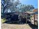 Large carport providing covered parking and additional workspace with storage at 2073 Cr 428, Lake Panasoffkee, FL 33538