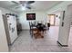 Bright dining area featuring tile floors, a ceiling fan, and a round wooden table with chairs at 2073 Cr 428, Lake Panasoffkee, FL 33538