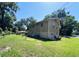 The exterior of this two-story home boasts a well-maintained lawn, and a charming blend of wood and brick accents at 2073 Cr 428, Lake Panasoffkee, FL 33538