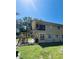 The exterior view of this home shows a brick foundation, wood siding, and outdoor stairs, offering both style and function at 2073 Cr 428, Lake Panasoffkee, FL 33538