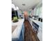 Spacious kitchen with modern wood-look flooring, white cabinets, and ample counter space for meal preparation at 2073 Cr 428, Lake Panasoffkee, FL 33538
