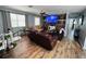 Cozy living room with a stone accent wall, comfortable seating, and natural light filtering through the windows at 2073 Cr 428, Lake Panasoffkee, FL 33538