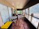 Enclosed outdoor porch with comfortable seating, tables and decor create a relaxing and inviting atmosphere for enjoying the outdoors at 2073 Cr 428, Lake Panasoffkee, FL 33538