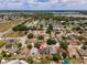 Aerial view of home in neighborhood with mature trees, lawns, and a lake at 181 Osprey Heights Dr, Winter Haven, FL 33880