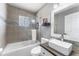 Well-lit bathroom with a shower-over-tub, vessel sink and tiled accent wall with modern finishes at 181 Osprey Heights Dr, Winter Haven, FL 33880