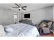 Bedroom features laminate floors, ceiling fan, media center, and comfortable seating at 181 Osprey Heights Dr, Winter Haven, FL 33880