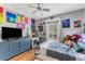 Charming bedroom with a ceiling fan and vibrant decor, including colorful wall art and decorations at 181 Osprey Heights Dr, Winter Haven, FL 33880