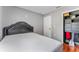 A neatly presented bedroom with a decorative headboard, a closet and a dollar sign wall decoration at 181 Osprey Heights Dr, Winter Haven, FL 33880