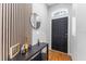 Modern foyer with a black front door, wood-look floors, stylish console table, and decorative wall accent at 181 Osprey Heights Dr, Winter Haven, FL 33880