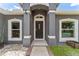Inviting front entrance with elegant columns, decorative windows, and a well-maintained walkway at 181 Osprey Heights Dr, Winter Haven, FL 33880