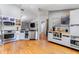 Bright kitchen featuring stainless steel appliances, white cabinetry, laminate floors, and functional layout at 181 Osprey Heights Dr, Winter Haven, FL 33880