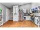 Bright kitchen featuring stainless steel appliances, white cabinets, laminate floors, and spacious layout at 181 Osprey Heights Dr, Winter Haven, FL 33880
