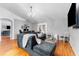 Comfortable living room with vaulted ceilings, wood laminate flooring, and a contemporary design at 181 Osprey Heights Dr, Winter Haven, FL 33880