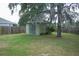 Backyard featuring a shed, fencing and mature trees at 1895 Snapper Dr, Kissimmee, FL 34759