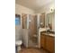 Bathroom featuring a glass enclosed shower, commode, and granite vanity top at 1895 Snapper Dr, Kissimmee, FL 34759