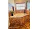 Bright bathroom featuring a garden tub with decorative tile and a large window at 1895 Snapper Dr, Kissimmee, FL 34759
