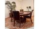 Dining area with a round wood table set for dining, complemented by a decorative plant at 1895 Snapper Dr, Kissimmee, FL 34759