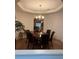 Formal dining room with a wooden table, upholstered chairs, and elegant chandelier at 1895 Snapper Dr, Kissimmee, FL 34759