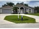 Charming single-story home with a well-manicured lawn, a two-car garage and inviting front entrance at 1895 Snapper Dr, Kissimmee, FL 34759