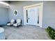 Cozy front porch sitting area with seating and decorative nautical accents at 1895 Snapper Dr, Kissimmee, FL 34759
