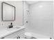 Modern bathroom featuring sleek fixtures, white subway tile in shower, and stylish mirror at 630 Pear St, Lakeland, FL 33815