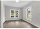 Bright and airy bedroom with multiple windows, laminate floors, and neutral color scheme at 630 Pear St, Lakeland, FL 33815