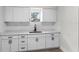 Bright kitchen with white cabinets, subway tile backsplash, and a stainless steel sink at 630 Pear St, Lakeland, FL 33815