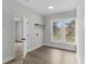 Bright laundry room with wood-look floors, open shelving, and lots of natural light at 630 Pear St, Lakeland, FL 33815