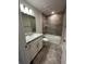 Bathroom featuring granite vanity top with tiled shower and flooring at 1259 Groveland Ln, Lakeland, FL 33811
