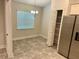 Dining area features a chandelier, window, tiled floor and a pantry at 1259 Groveland Ln, Lakeland, FL 33811