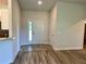 Clean entryway with tile flooring, a white front door, and neutral wall paint at 1259 Groveland Ln, Lakeland, FL 33811