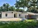 Charming single-story home with a simple facade, dark gray roof, and unfinished landscaping at 1259 Groveland Ln, Lakeland, FL 33811