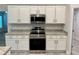 Kitchen with modern stainless steel appliances and white cabinets at 1259 Groveland Ln, Lakeland, FL 33811
