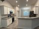 Modern kitchen features stone countertops, stainless steel appliances, and a breakfast bar overlooking dining area at 1259 Groveland Ln, Lakeland, FL 33811