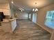 Bright, open-concept living room with wood flooring and modern light fixtures at 1259 Groveland Ln, Lakeland, FL 33811