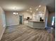 Spacious living area flows into a kitchen with stone countertops and stainless steel appliances at 1259 Groveland Ln, Lakeland, FL 33811