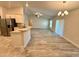 Open-concept living space with wood floors, island, and natural light at 1259 Groveland Ln, Lakeland, FL 33811