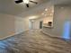 Open-concept living area with vaulted ceilings, wood-look flooring, and views into the modern kitchen at 1259 Groveland Ln, Lakeland, FL 33811