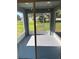 Enclosed screened patio with ceiling lights and door to yard at 1259 Groveland Ln, Lakeland, FL 33811
