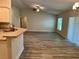 Open-concept living room featuring modern light fixtures and ceiling fan at 1265 Groveland Ln, Lakeland, FL 33811