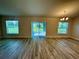 Inviting living area with wood-look floors, abundant natural light, and sliding glass door access at 1265 Groveland Ln, Lakeland, FL 33811