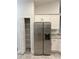 Pantry closet featuring shelving and modern, stainless steel refrigerator at 1265 Groveland Ln, Lakeland, FL 33811