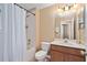 Well-maintained bathroom with a shower-tub combo, wooden vanity, and a bright, neutral color scheme at 2417 Passamonte Dr # 1E, Winter Park, FL 32792