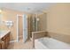 Well-appointed bathroom with a soaking tub, glass-enclosed shower, and modern fixtures, designed for relaxation at 2417 Passamonte Dr # 1E, Winter Park, FL 32792