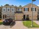Charming townhome featuring a brick-paved driveway and attached garages, perfect for comfortable living at 2417 Passamonte Dr # 1E, Winter Park, FL 32792